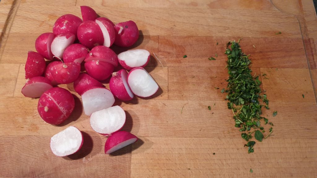 Radishes and fresh thyme on a chopping board