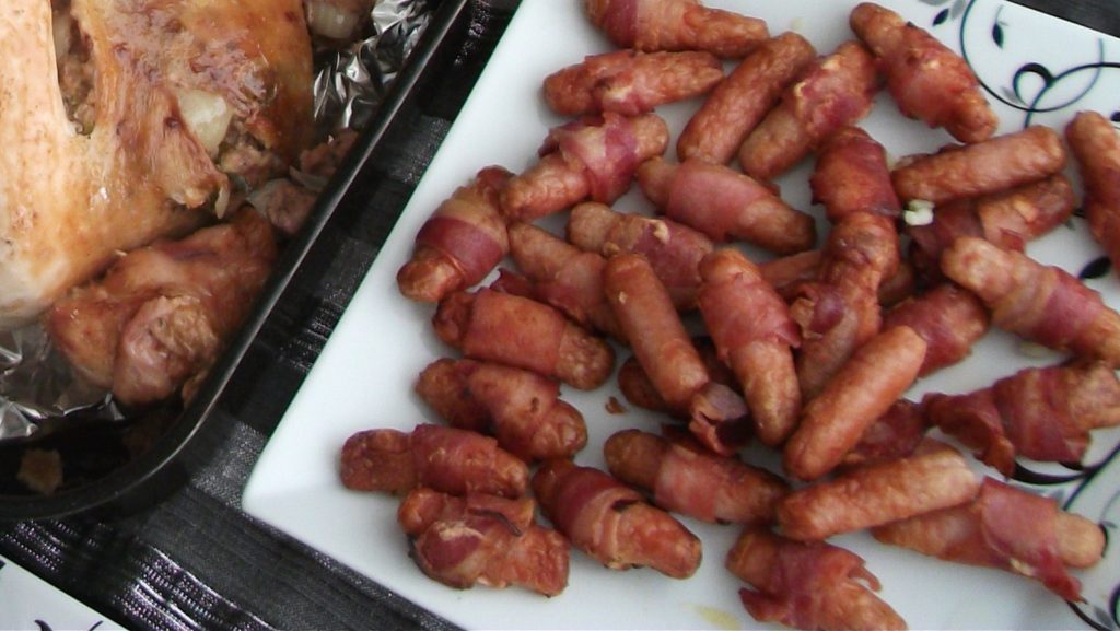 Pigs in blankets (sausages wrapped in bacon) on a plate